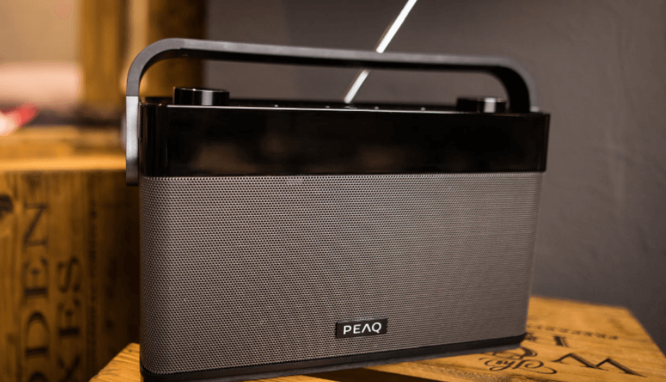 PEAQ digital radio on a wooden wine box, surrounded by other boxes, close-up